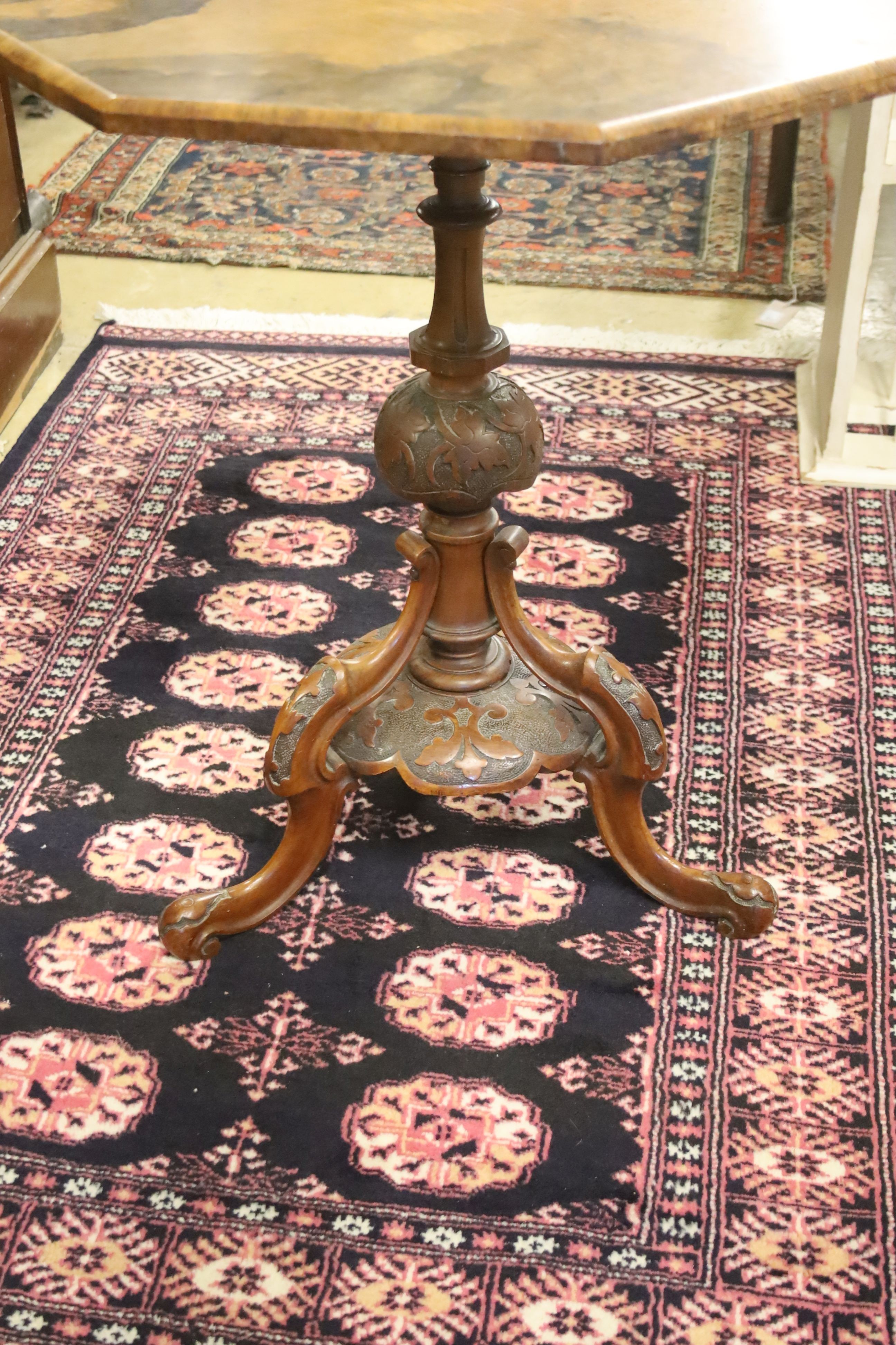 A Victorian burr walnut octagonal topped tea table, raised on leaf carved pillar and open scrolled cabriole tripod base, width 58cm, height 65cm